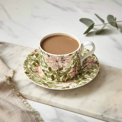 honeysuckle teacup & saucer on a marble slab with mug filled with tea