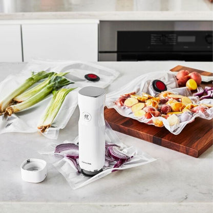 vacuum pump and three bags on counter with food