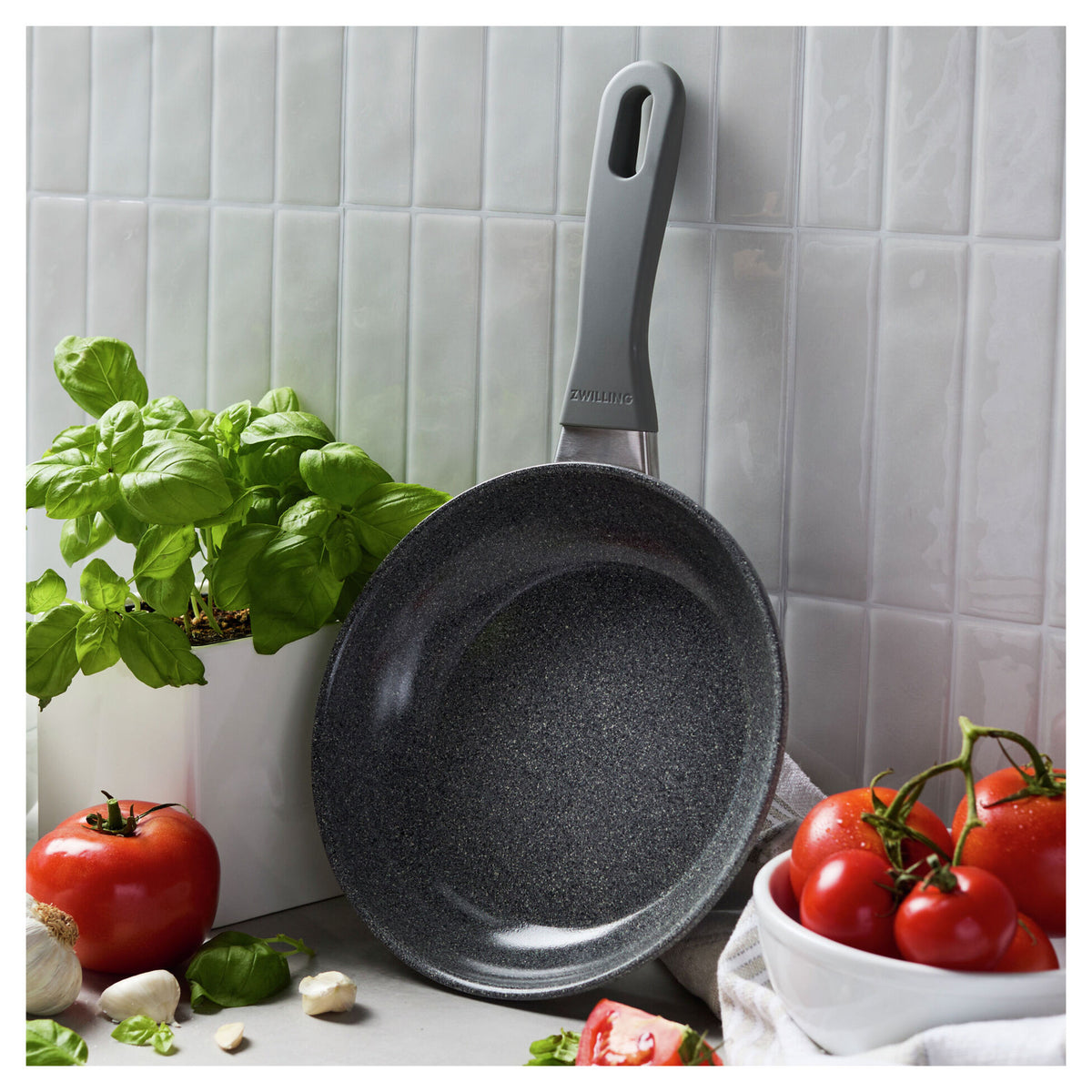 8" Parma Plus, Nonstick Ceramic Fry Pan leaning against a wall next to produce