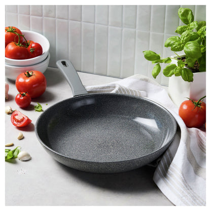 12" Parma Plus, Nonstick Ceramic Fry Pan in a kitchen next to a towel and produce