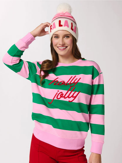 smiling person wearing green and pink striped shirt and fa ls ls beanie