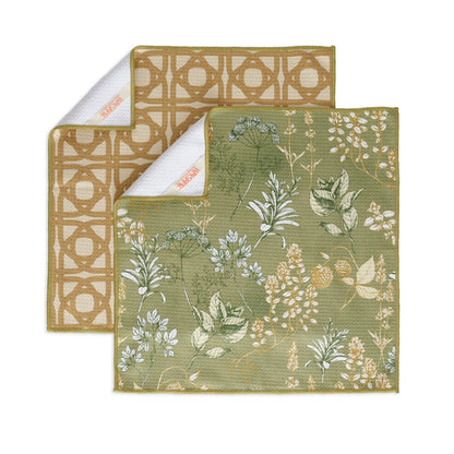 Two different patterns of kitchen herb towels arranged on a white background with corners flapped over, showing hanging loop.
