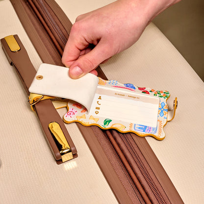 hand opening flap on colorful luggage tag to show label for personal information