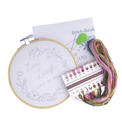 Embroidery kit with hoop, thread, and stitch guide on a white background