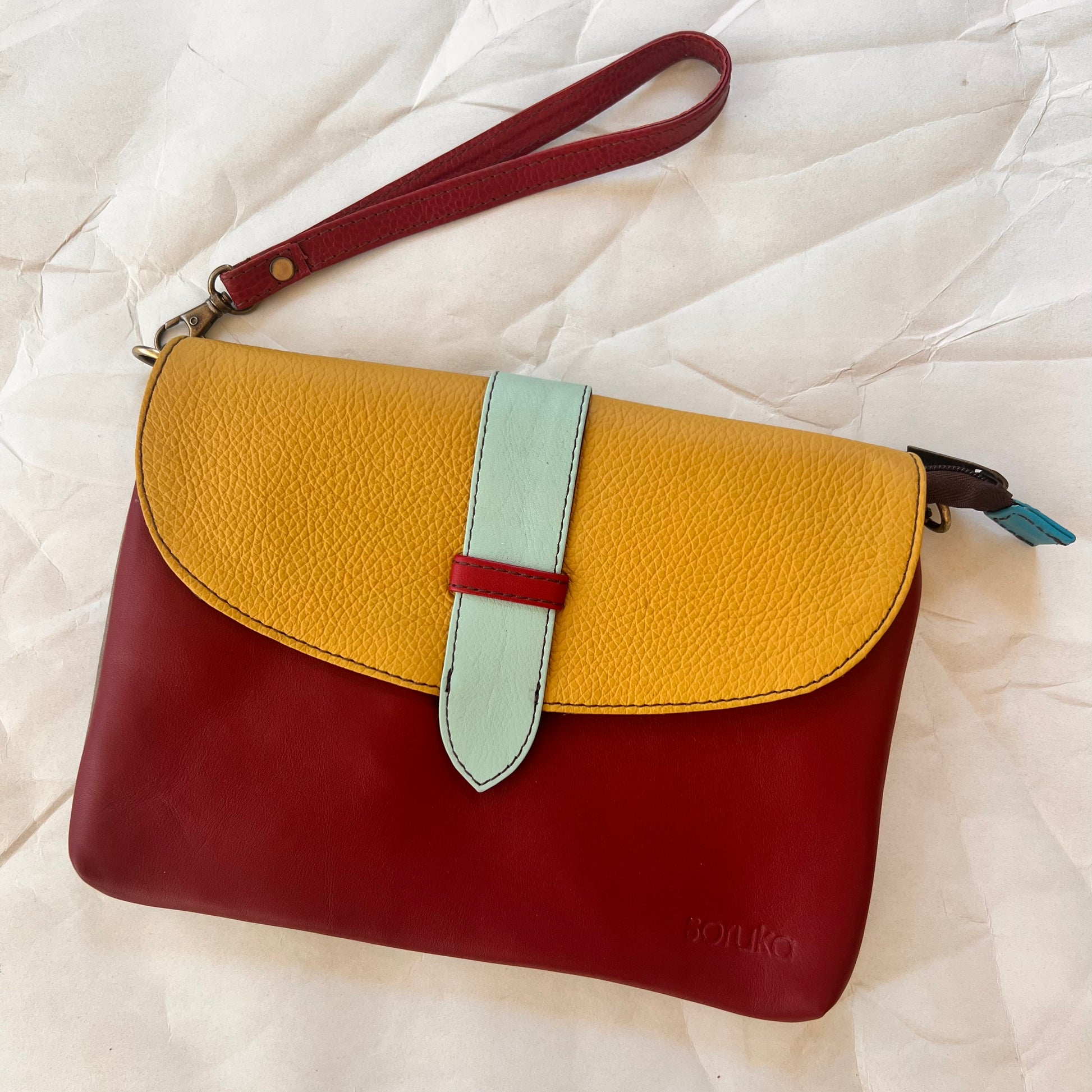 saddle bag with wristlet strap attached.