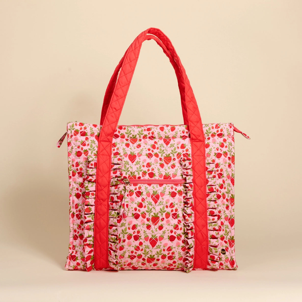 strawberry patterned tote bag with red accents on a beige background