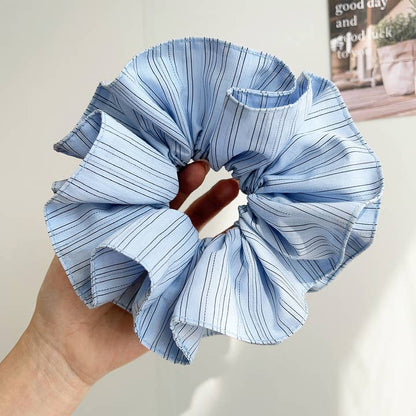 blue pinstripe scrunchie being held