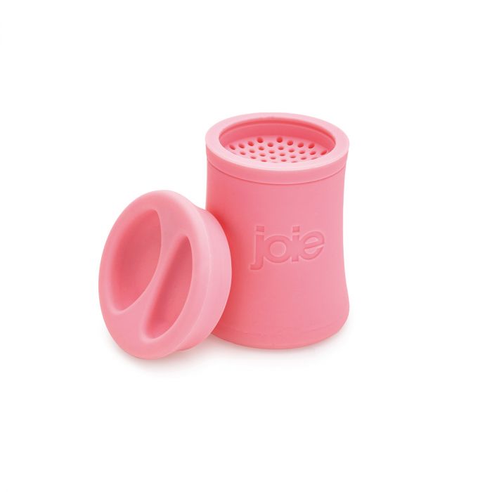 pink silicone grease keeper with snout shaped lid set next to it.