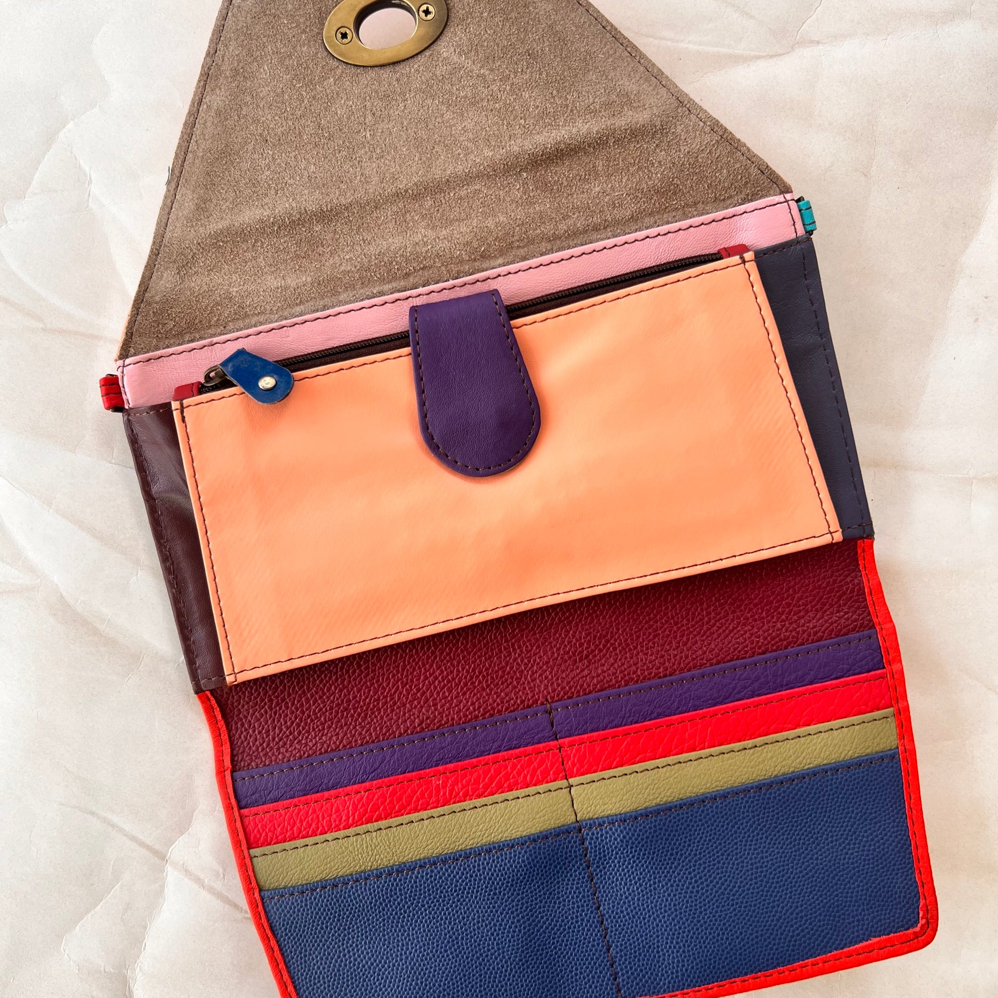interior view of secret clutch wallet showing colorful card slots and other pockets.