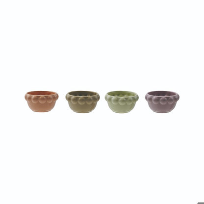 ceramic little bowls with bubble rims in a row on a white background