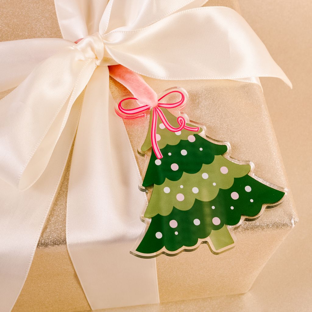 flat dark and light green acrylic ornament tied on a package