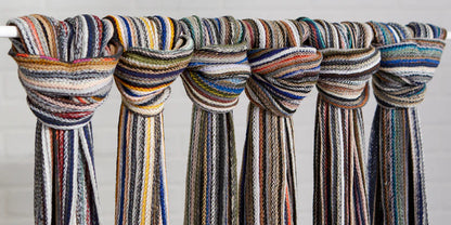 Cheerful Multi-Color Fringe Scarfs knotted along a wooden dowel
