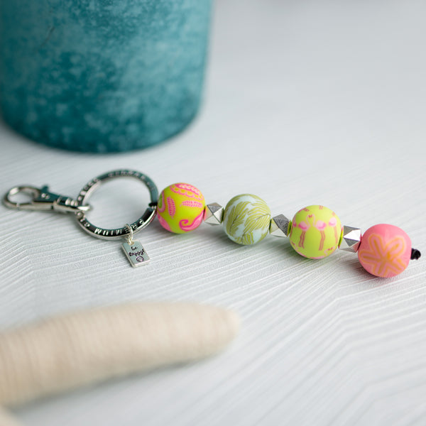 keychainw ith pink and green patterned beads, silver spacer beads, and silver keyring.