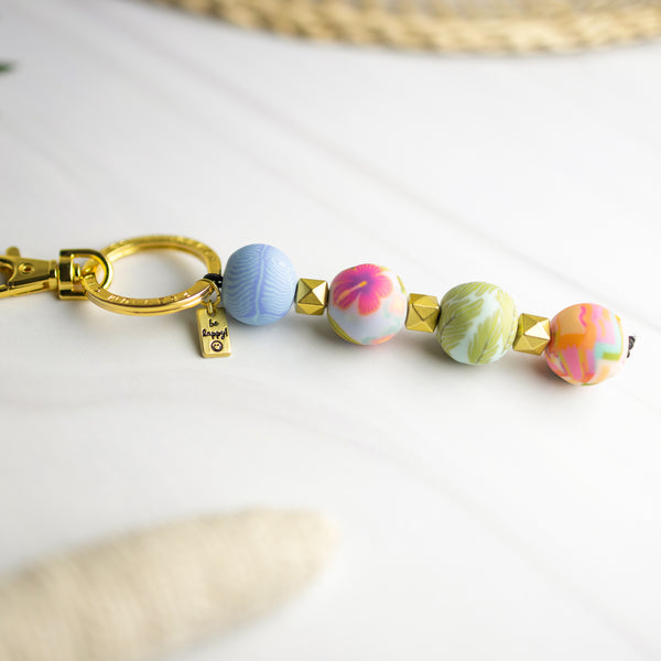 keychain with 4 multi colored beads, gold spacer beads, and gold keyring.