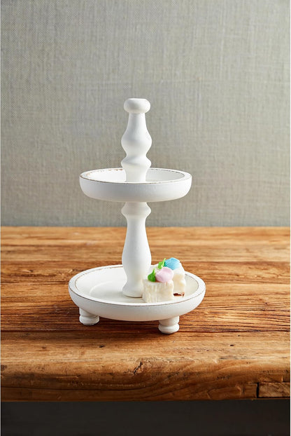 White Two Tier Server set on a table with small cakes on it