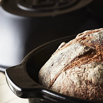 close-up of bread pot with a baked loaf of bread in it.