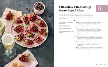 A two-page spread from recipe book featuring 'Chocolate Cheesecake Strawberry Bites'. The left page shows a styled food photograph of the prepared strawberry bites served on a pink plate, accompanied by a glass of white wine and a bowl of chocolate chips.