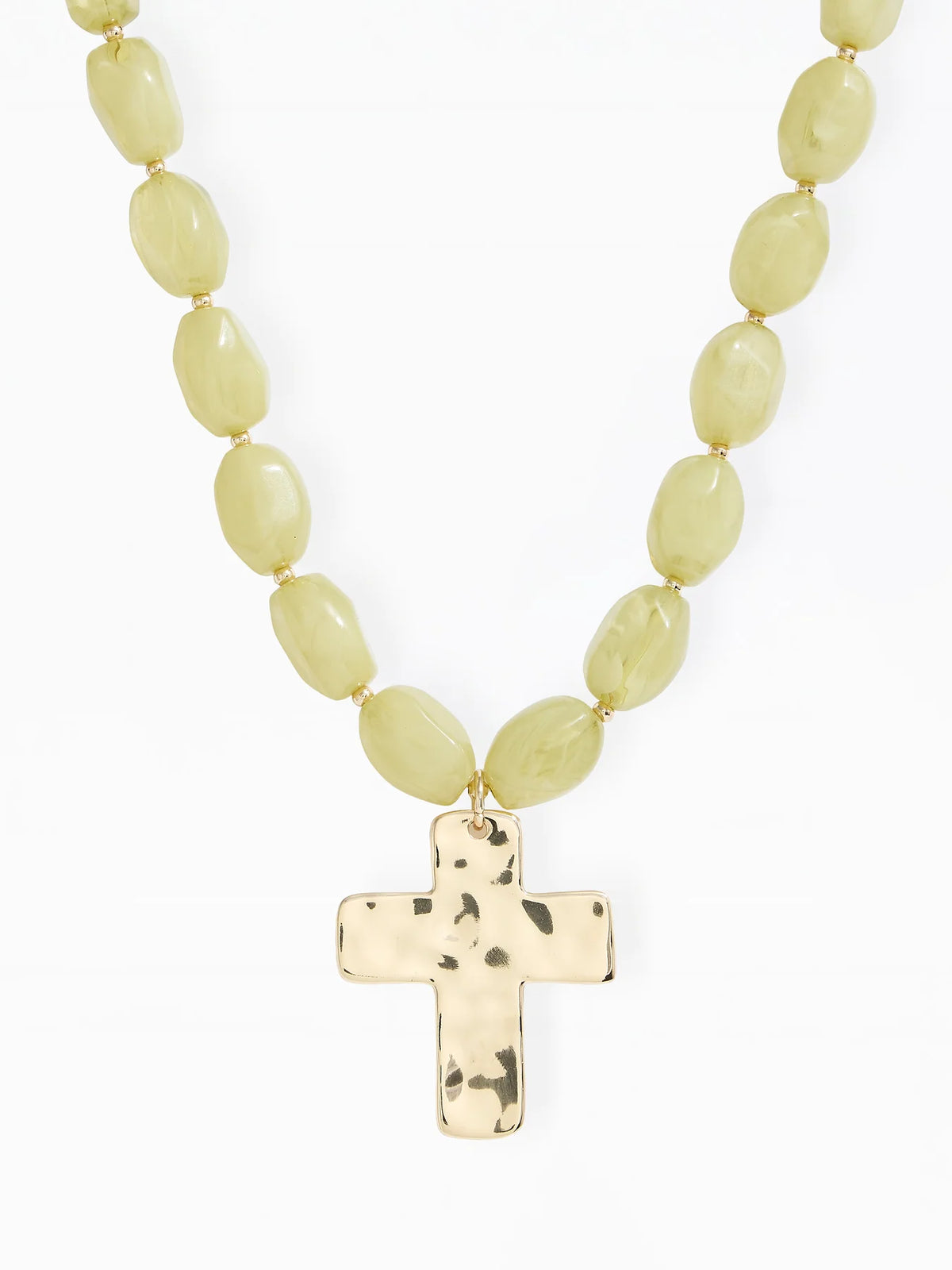 A beaded necklace with pale yellow-green oval beads and a textured gold cross pendant, shown against a plain white background.