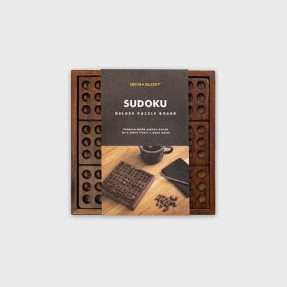 Wooden Sudoku game with card packaging wrapped around it.