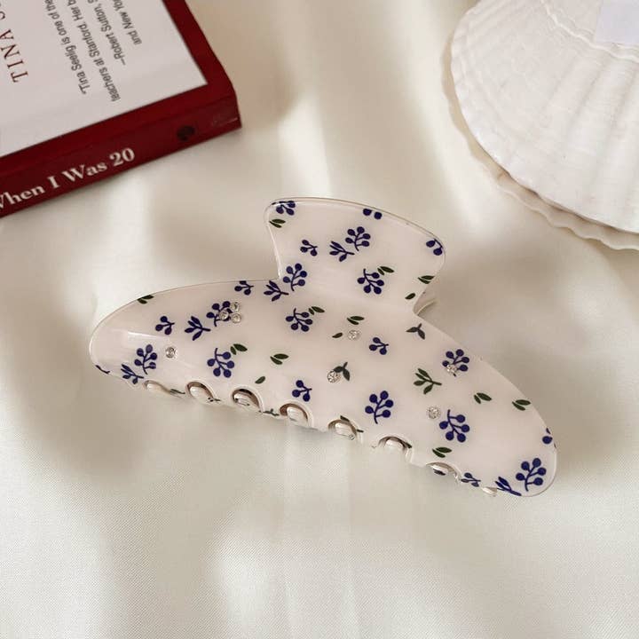 Blueberries & Rhinestones Claw Clip on a table