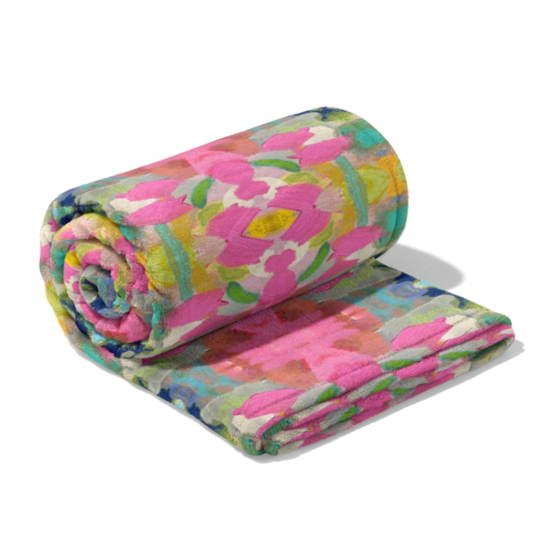 pink paradise fleece blanket folded and shown on a white background