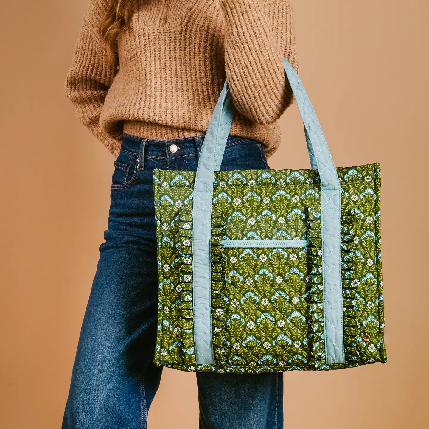 person wearing jeans and a sweater carrying Everbloom Forest Green tote