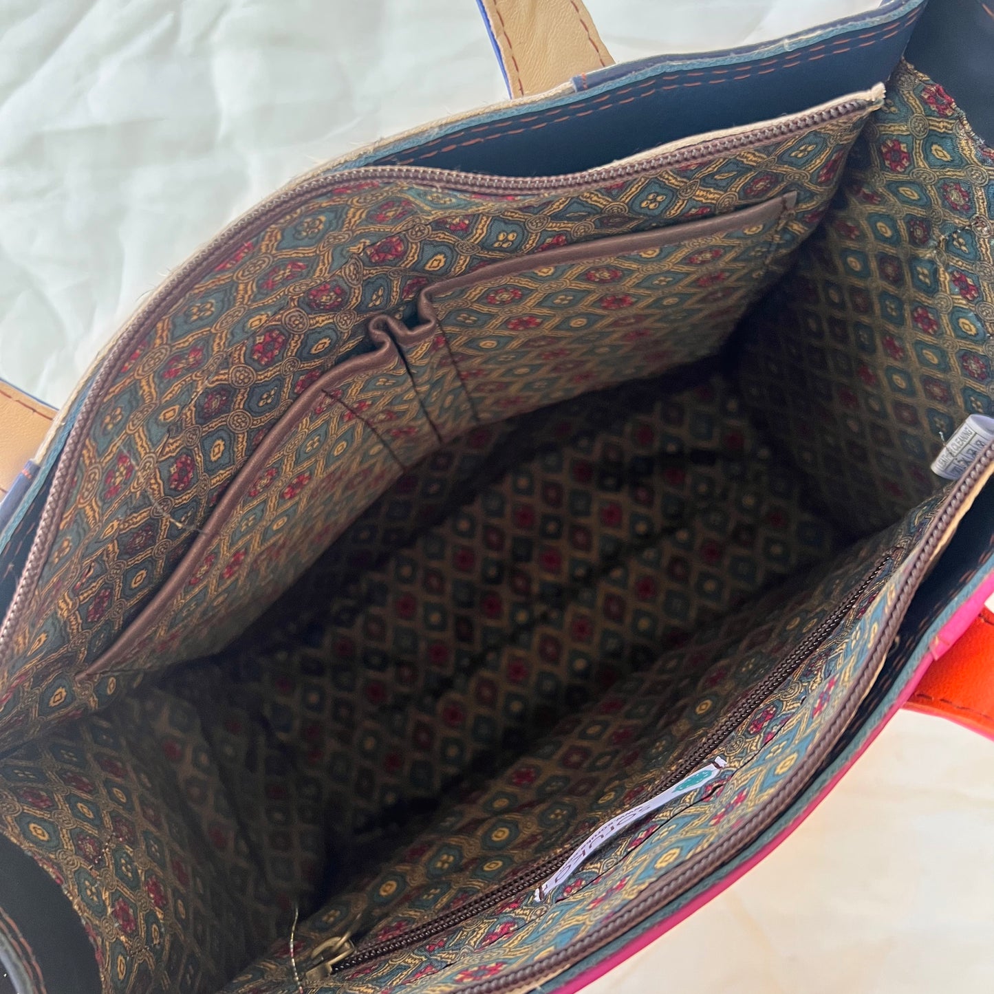 interior view of Giselle tote showing slip and zip pockets.