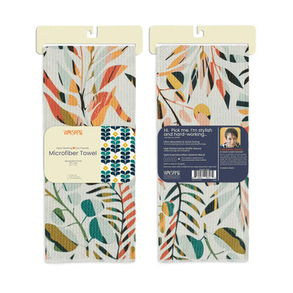 Front and back views of the colorful leaves dish towel folded in its card packaging.