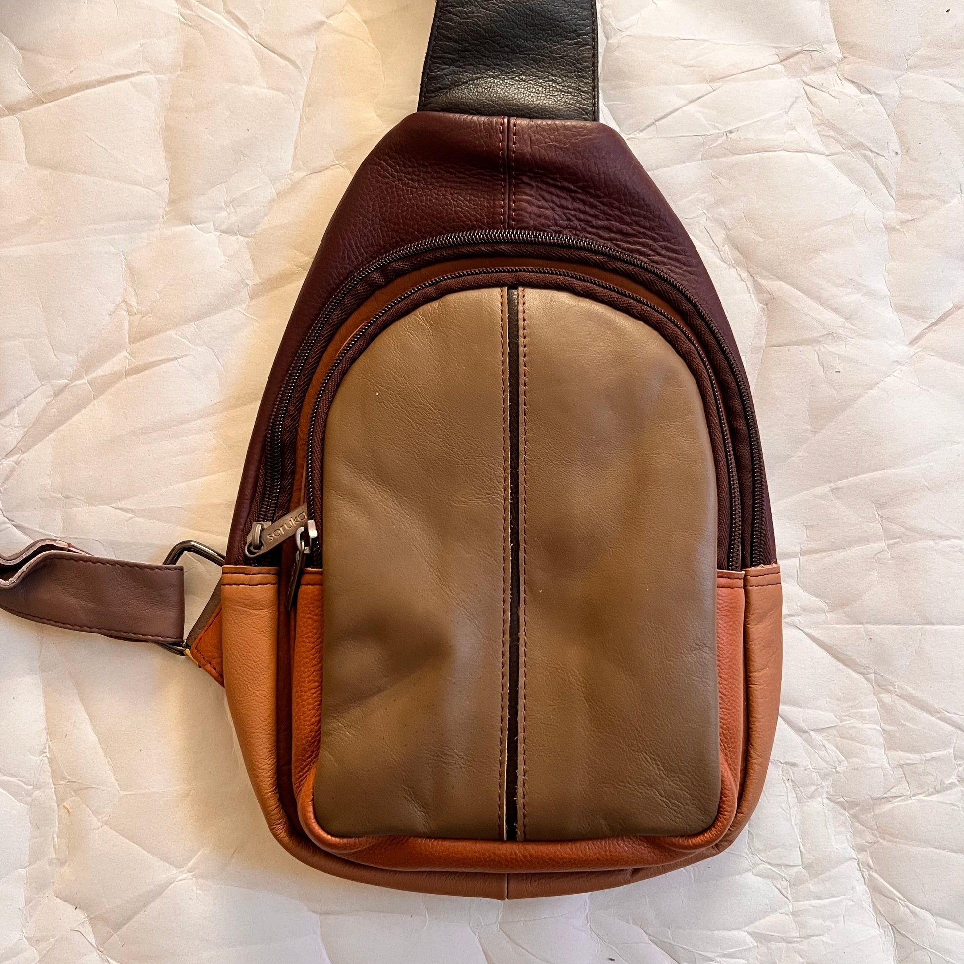 front view of taupe Gregg sling bag.