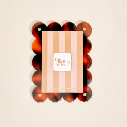 Scalloped tortoise magnetic frame on a white background.