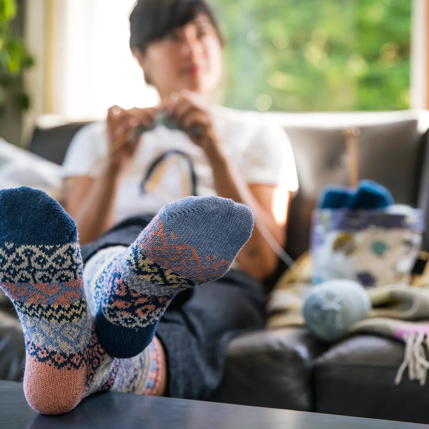 person sitting on a couch with their feet on a coffee table wearing Mirage Crew Socks