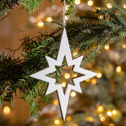 star cutout ornament displayed on a lighted christmas tree