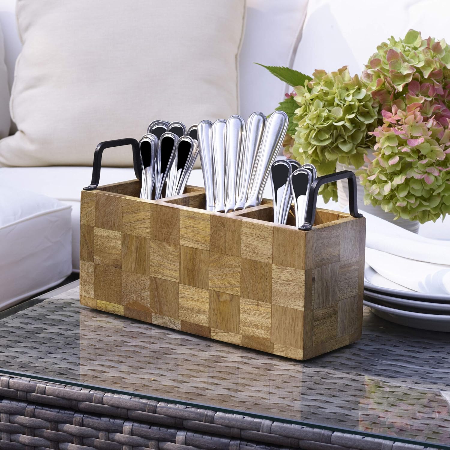 wooden 3 section caddy with metal handles set on a table and  filled with flatware.