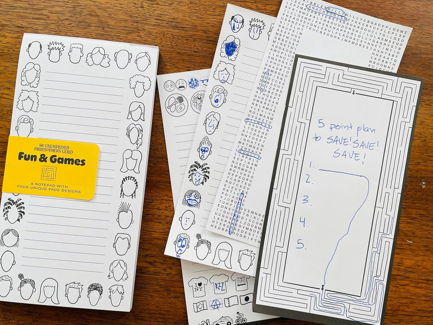 pages from fun and game notepad on a wooden surface