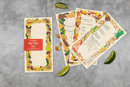 pages from the Pad Thai Notepad and lime slices shown on a grey background