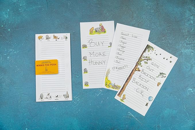 pages from Winnie the Pooh Notepad set on a textured blue surface