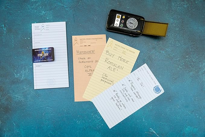 Notepad pages and a phone on a textured blue surface
