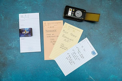 Notepad pages and a phone on a textured blue surface