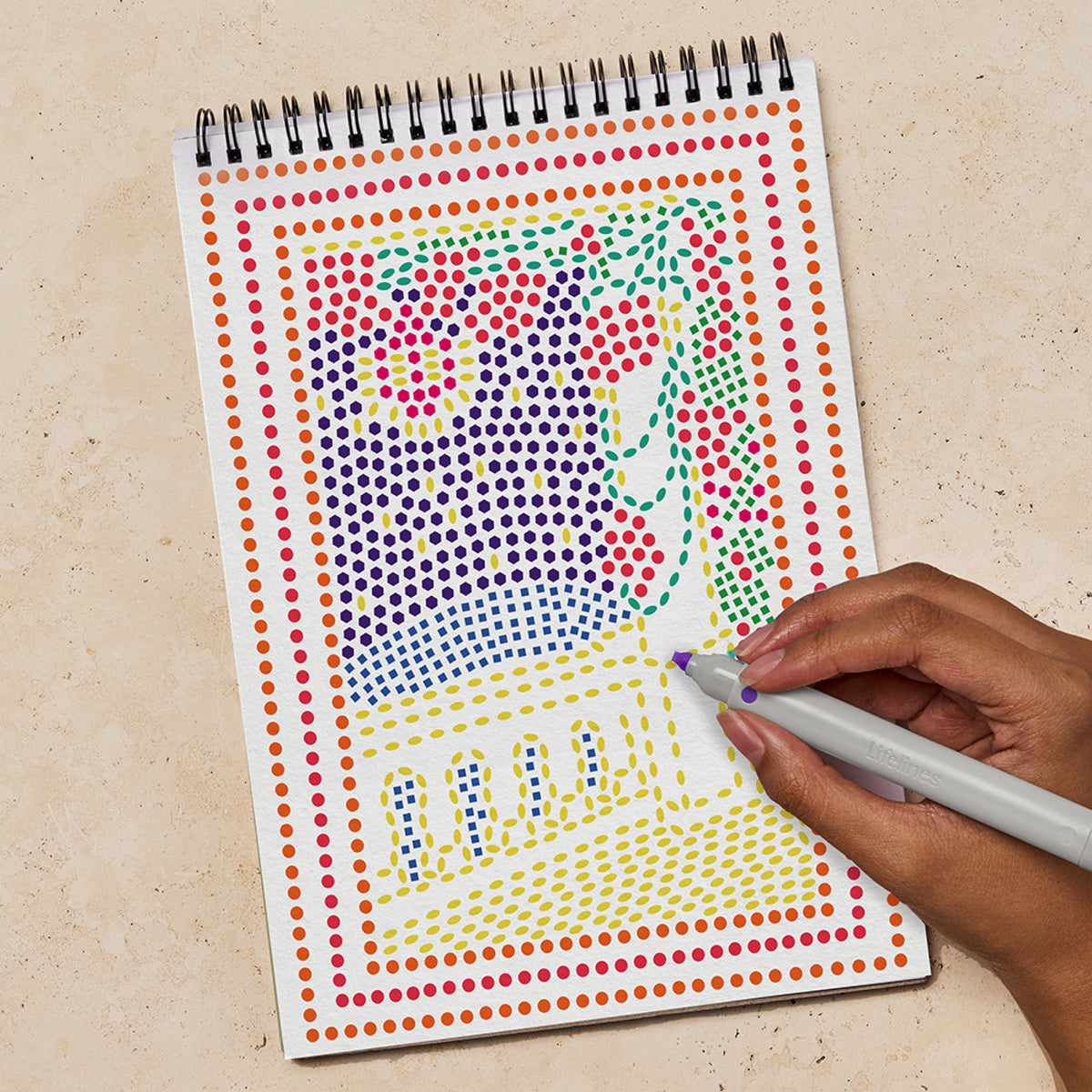 a person coloring the shapes with a marker