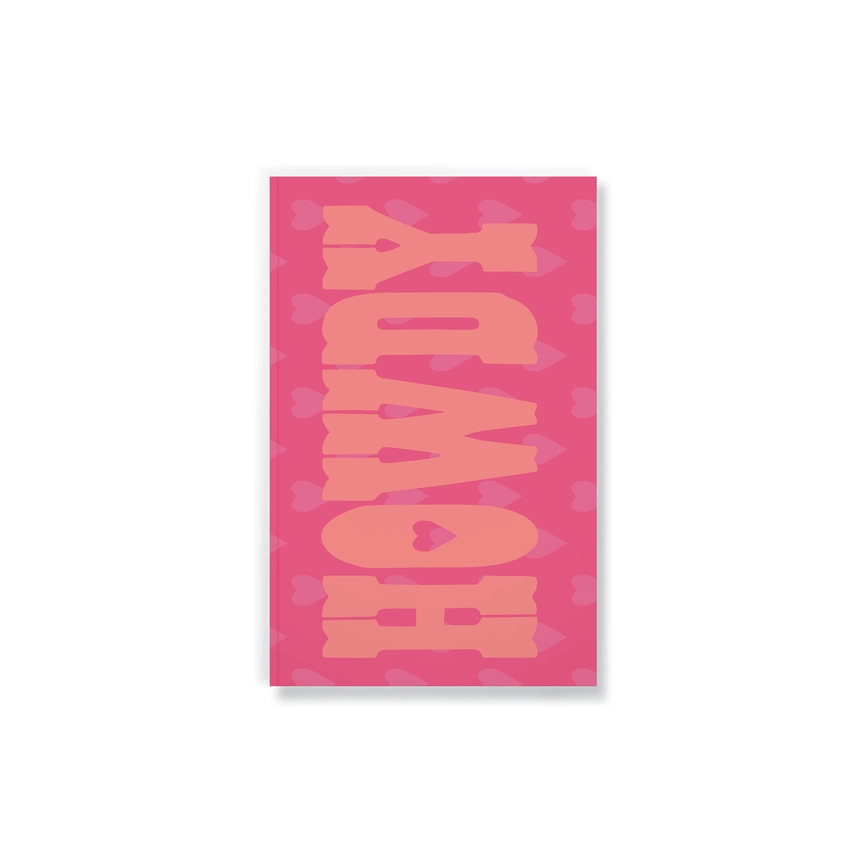 pink notebook covered in hearts and "howdy" printed on it.