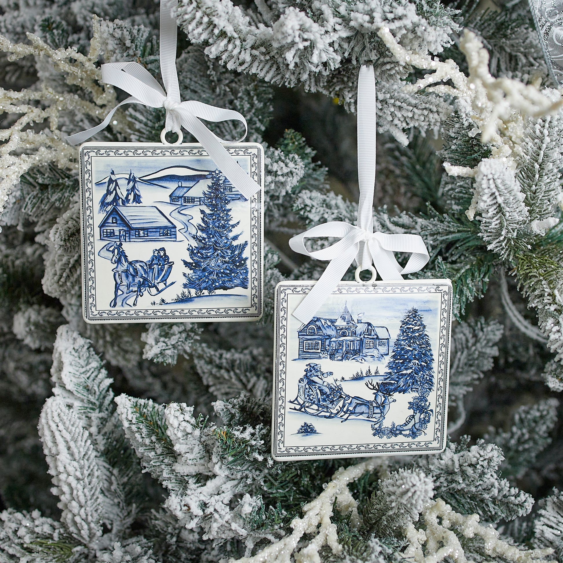 2 styles of winter scene ornaments hanging on a tree.