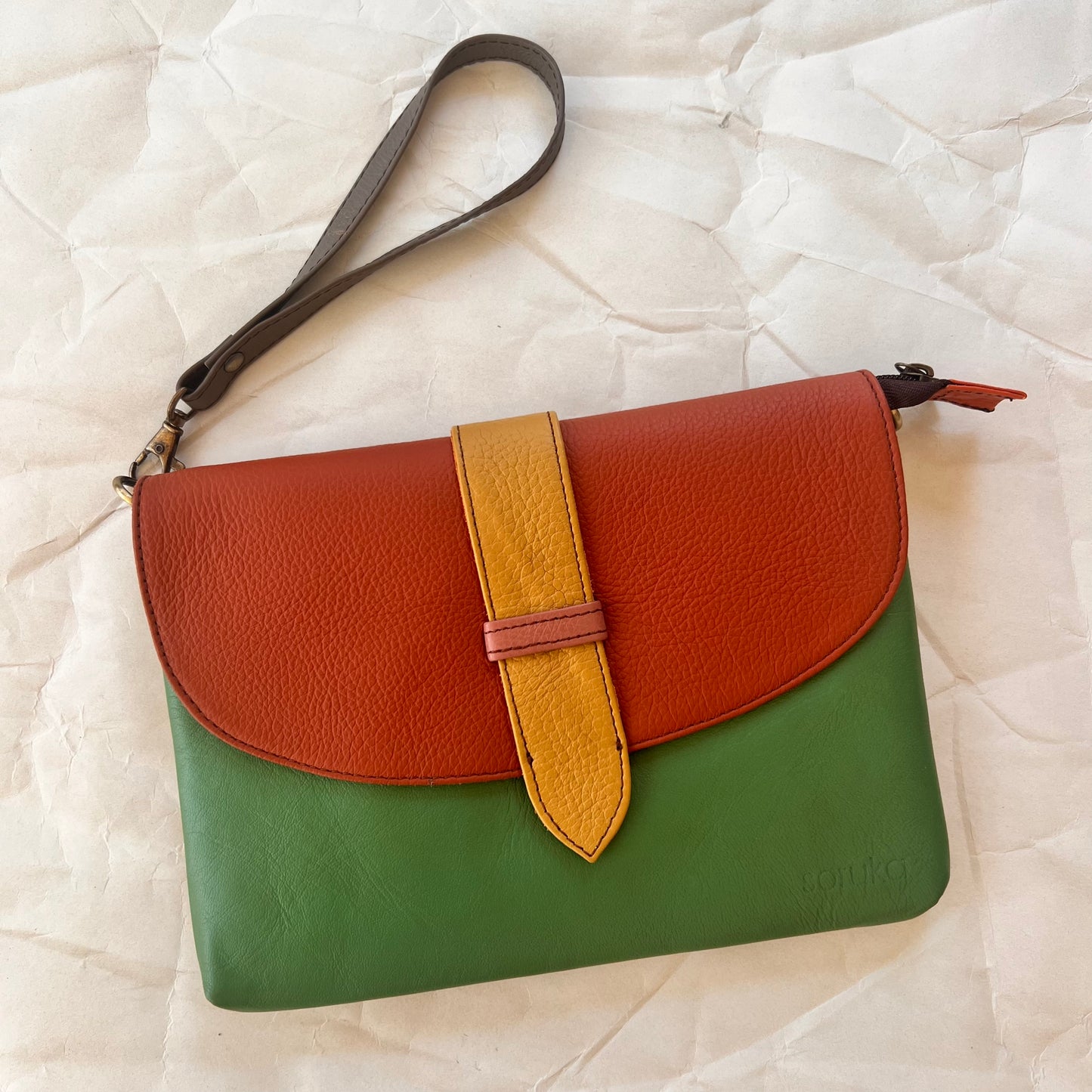 saddle bag with wristlet strap attached.