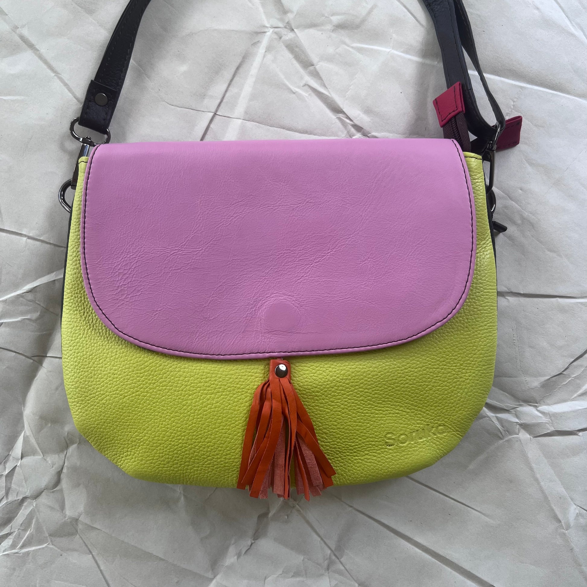 Lola Reversible Crossbody with yellow body, pink flap and orange tassel