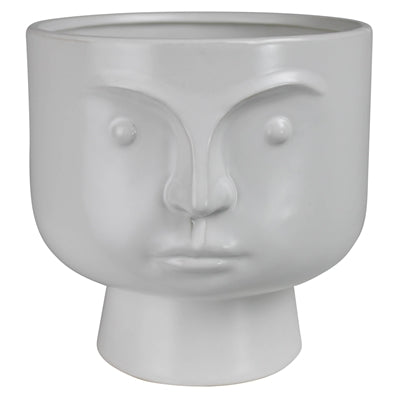 white ceramic pot with stoic face of it