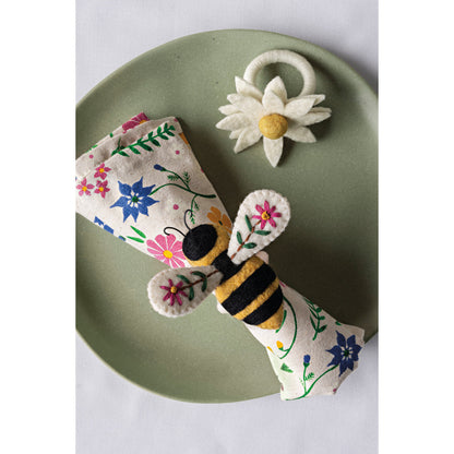 bee garden napkin on a green plate with bee napkin ring on it