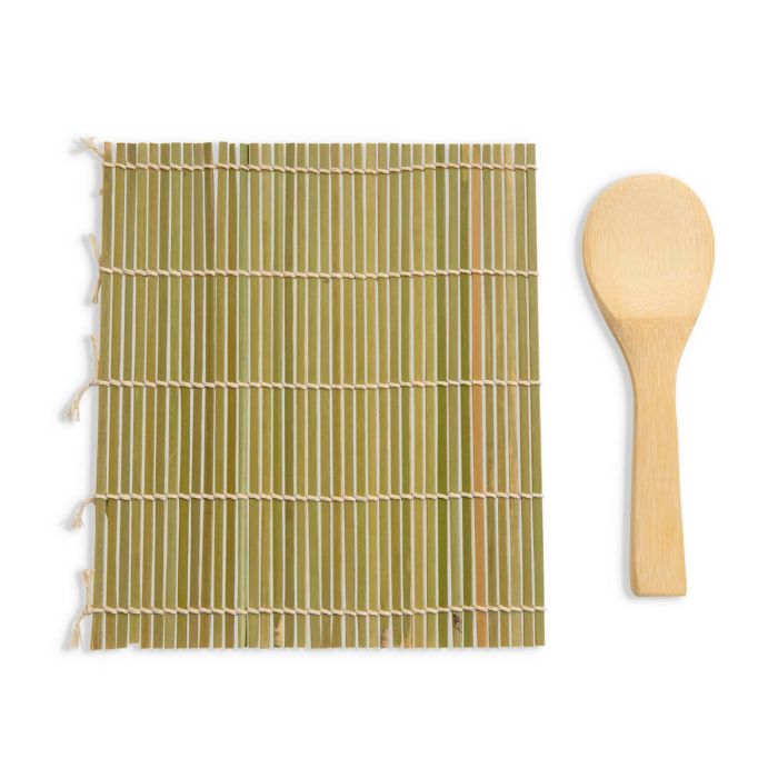 Bamboo mat with a wooden spoon nest to it on a white background