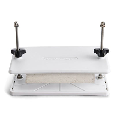 tofu press with tofu in it shown on a white background