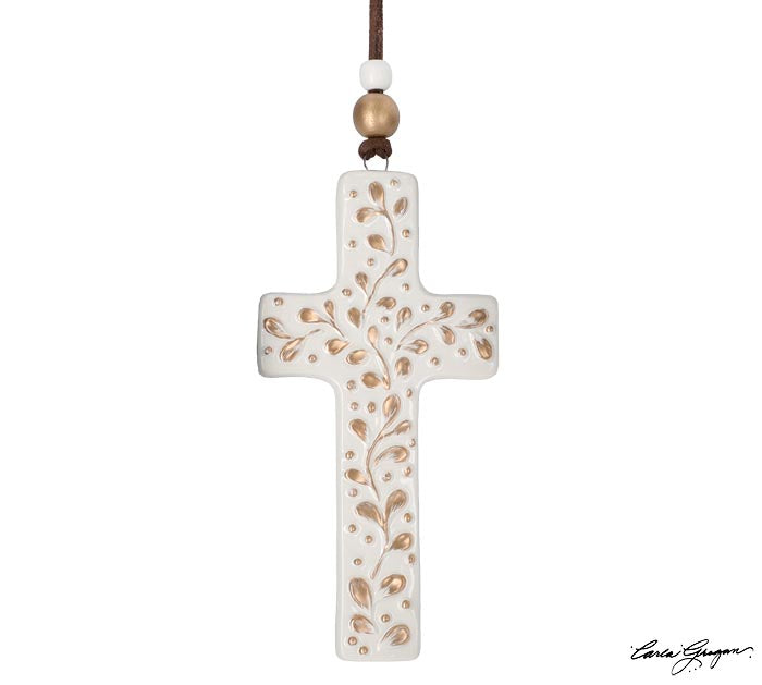 ivory crossed shape ornament with gold leaves all over and displayed against a white background