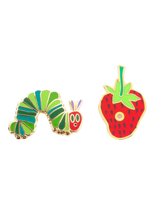 hungry caterpiller enameled pin next to a strawberry with a hole in it enameled pin 