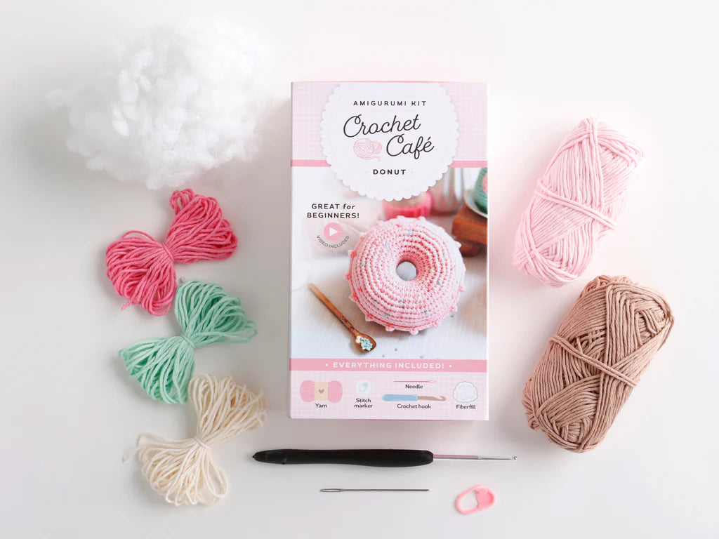 Crochet kit with yarn and tools on a white background